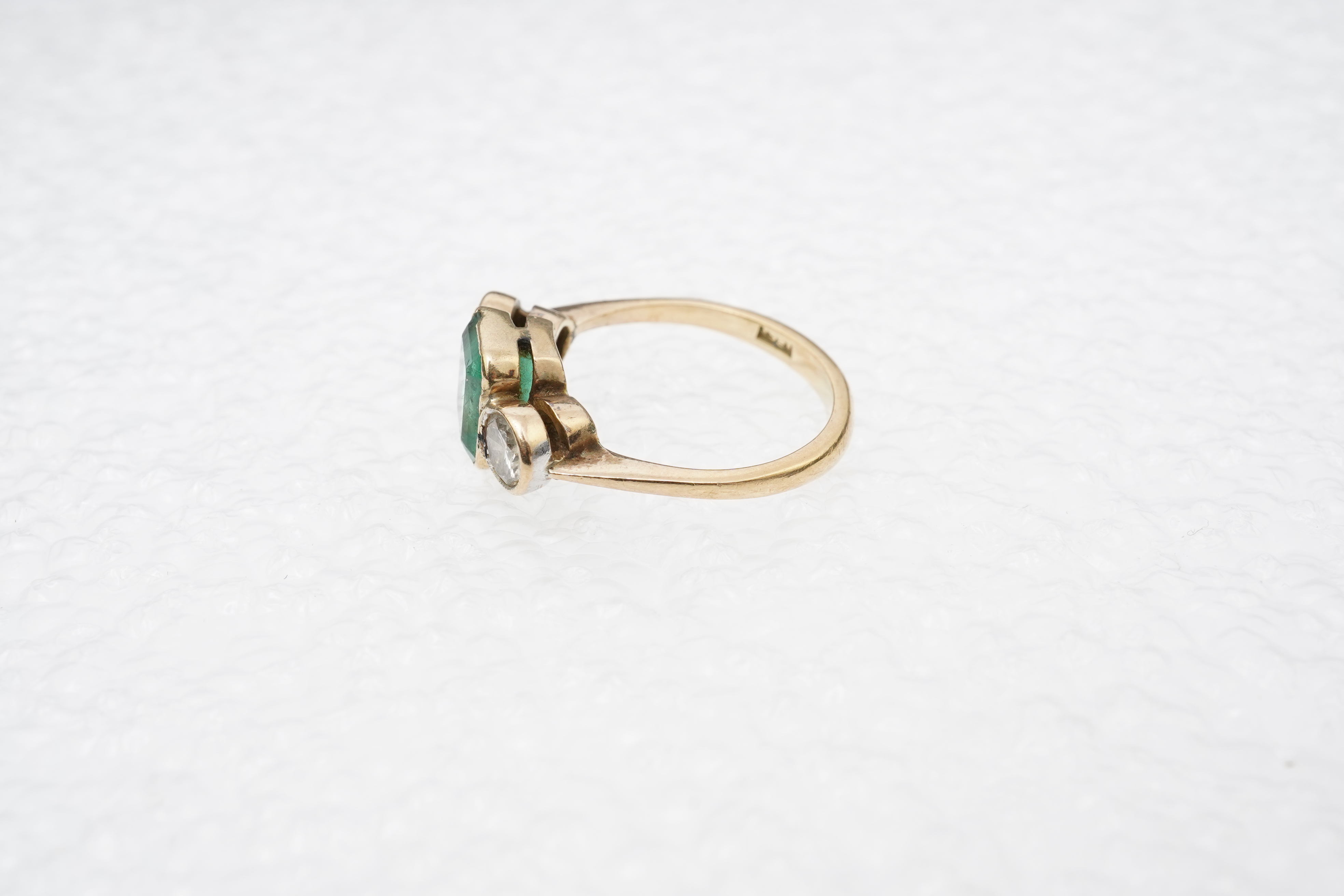 An emerald and diamond ring